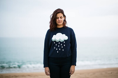 Portrait of woman against stormy beach