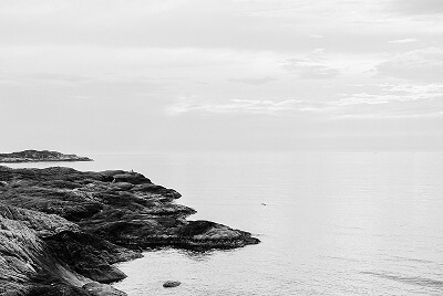 Fjord rocks extending into ocean